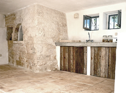 Antique thick Limestone slabs milled at 3" in thickness used as a bath tub surround in a master bathroom, salvaged from the bottom of farm house foundations